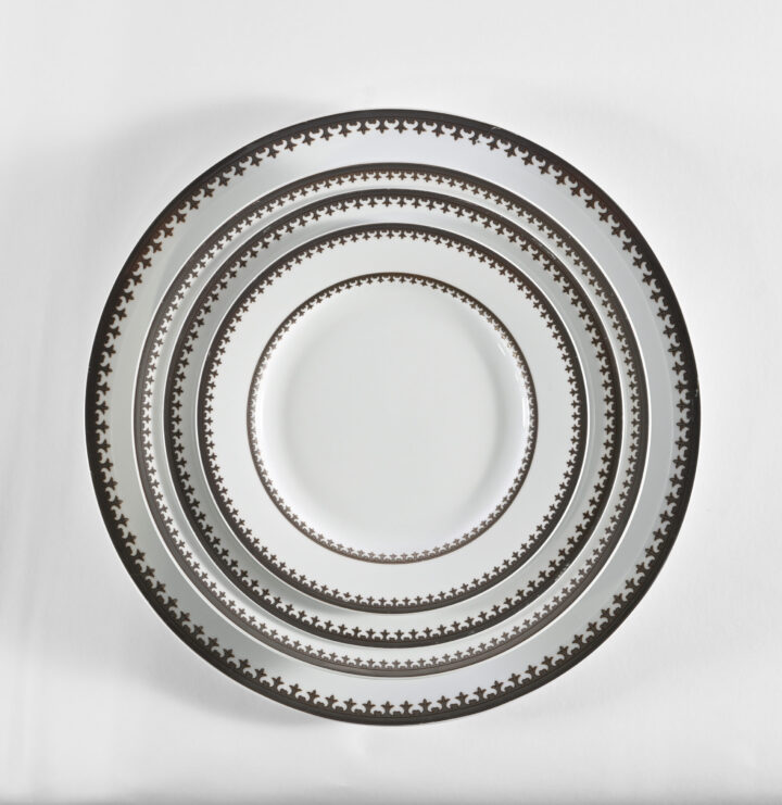 Nottingham dinnerware collection featuring a classic white porcelain design with an elegant dark patterned border. Includes Bread & Butter Plate (6.25"), Salad / Dessert Plate (7.25"), Soup Rim (8.5"), Dinner Plate (10.25"), Demitasse Cup & Saucer, and Coffee / Tea Cup & Saucer. Perfect for timeless, formal table settings and refined dining presentations.