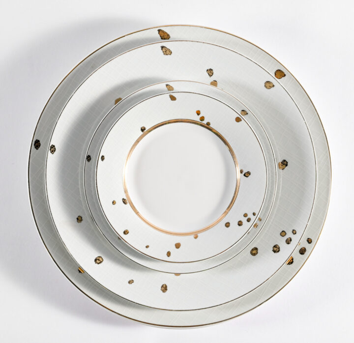 Spectrum dinnerware collection featuring a modern white base with hand-applied gold speckle detailing and metallic rim accents. Includes Bread & Butter Plate (6.5"), Salad / Dessert Plate (7.25"), Soup Rim (8.5"), Dinner Plate (10.5"), Demitasse Saucer, Demitasse Cup, Coffee / Tea Saucer, and Coffee / Tea Cup. A refined, contemporary option for elegant dining presentations.