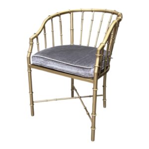Bamboo Armchair in golden finish featuring a faux bamboo metal frame with a curved back.