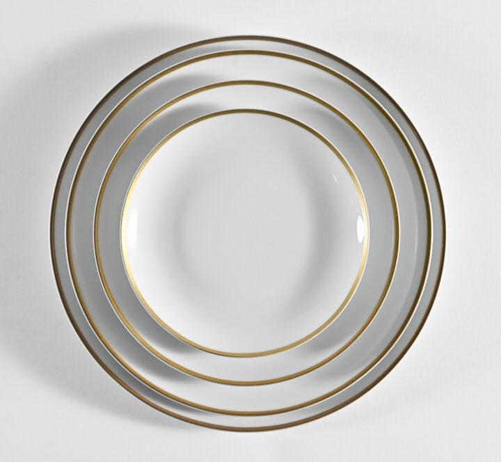 Coupe Gold Rim Collection featuring elegant white porcelain plates with a fine metallic gold rim. Includes Bread & Butter Plate (6.5"), Salad Plate (8"), Luncheon Plate (9.75"), Dinner Plate (10.625"), Coffee Saucer, and Coffee Cup. A timeless and luxurious dinnerware choice perfect for weddings, galas, and formal events.