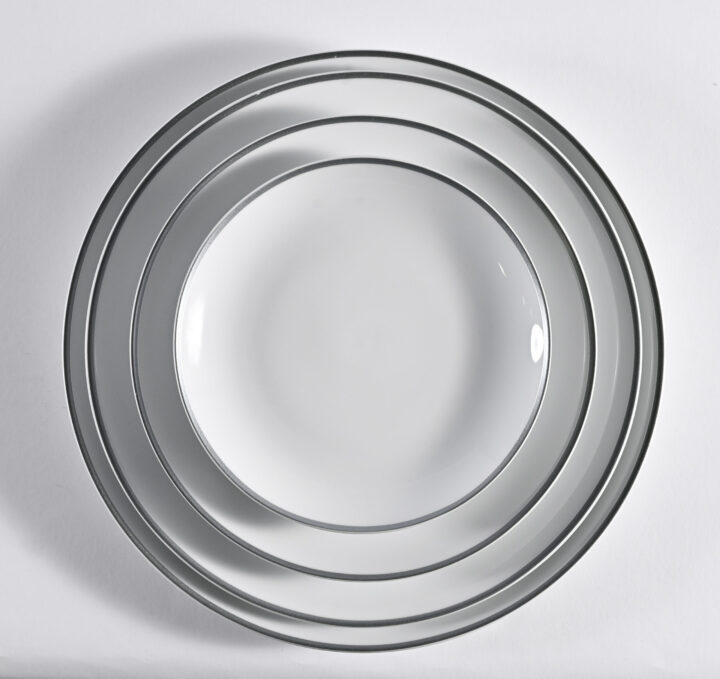 Coupe Silver Rim China Collection featuring elegant white porcelain plates accented with a refined metallic silver rim. Includes Bread & Butter Plate (6.5"), Salad Plate (8"), Luncheon Plate (9.75"), Dinner Plate (10.625"), Coffee Saucer, and Coffee Cup. A timeless and sophisticated choice for weddings, galas, and upscale dining.