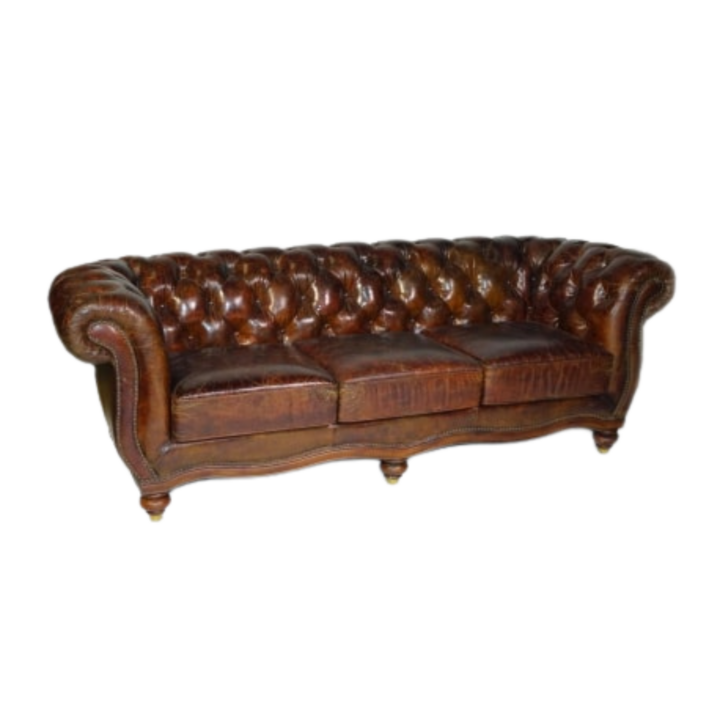 Vintage Chesterfield brown leather sofa with deep button tufting, rolled arms, and nailhead trim, ideal for lounge seating and upscale event décor.