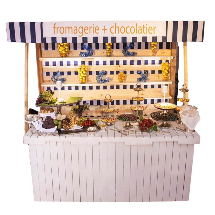 Farmer’s Market Stand measuring 10'L x 4'W x 9'H. Features a white wooden base with slatted design, striped navy-and-white awning, and open shelving for display—perfect for themed food stations, beverage service, or decorative event setups.