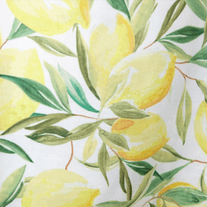 Limoncello Linen featuring a vibrant lemon and green leaf pattern on a white background. The fabric has a fresh, summery design ideal for event tables and outdoor gatherings. Available in 60", 132" round, and 20”W x 10’L table runner sizes.