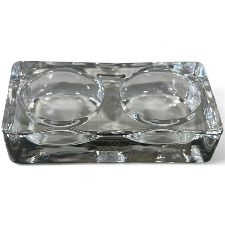 Clear rectangular glass salt and pepper cellar with two round compartments, designed for serving condiments or seasonings.