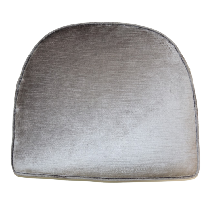 Grey velvet chair cushion with rounded top and flat bottom edges.