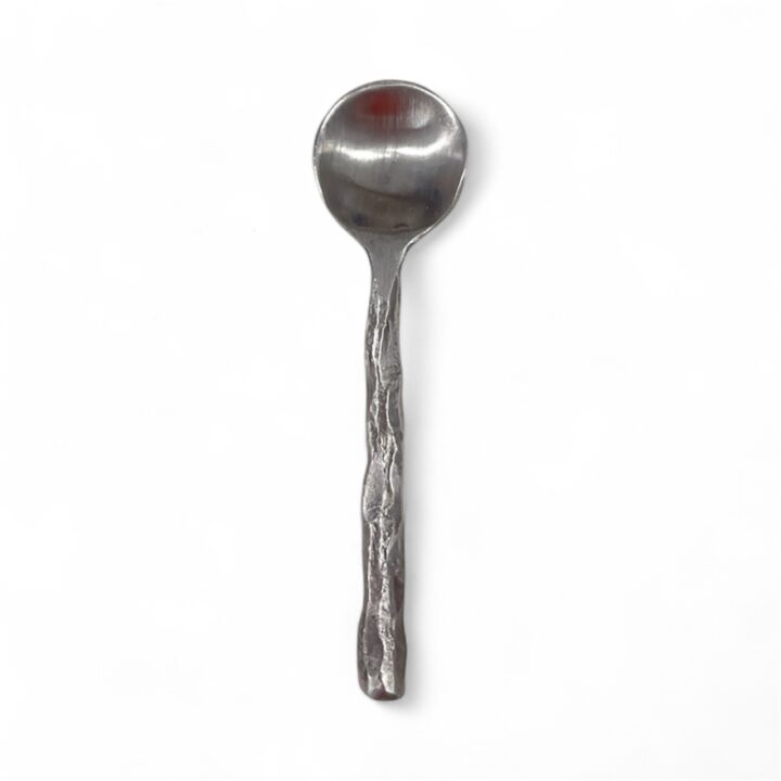 Silver salt and pepper cellar spoon with a small round bowl and an organically textured handle featuring a hand-forged appearance, displayed against a white background.