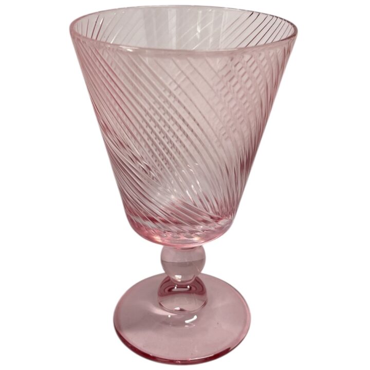 Pink glass goblet with a tapered bowl, diagonal swirl pattern, and rounded stem. The glass has a soft blush hue and holds approximately 10 ounces.