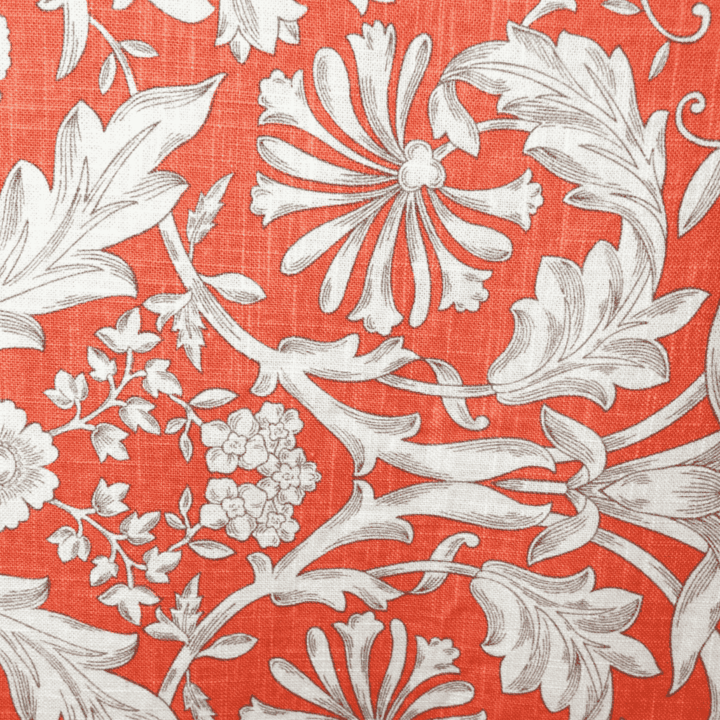 Rectangular coral linen with a white floral flourish pattern. The design features large, intricate botanical motifs on a textured coral background, measuring 108" x 156".