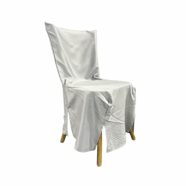 Cross Back Chair Cover in soft white fabric designed to drape elegantly over wooden chairs. Features tailored seams and front slits for a clean, refined look—perfect for weddings, banquets, and upscale event settings.