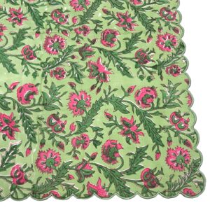 Scalloped dinner napkin in pink and green with a detailed floral block print and scalloped stitched edge.
