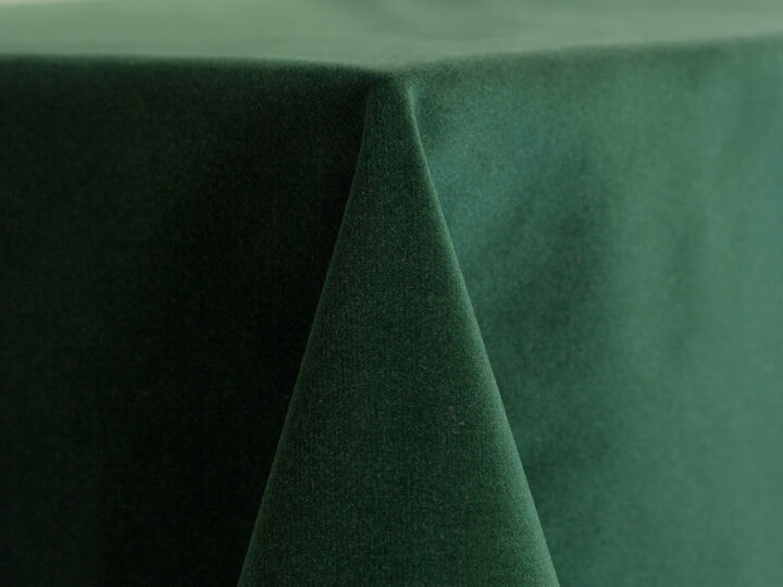 Hunter green velvet drape with a soft, plush texture, shown hanging with smooth folds for a rich, dramatic backdrop.