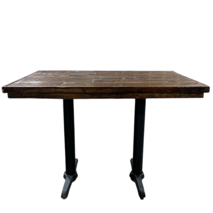 Rectangular reclaimed wood table with a rustic plank-style wood top and black metal pedestal legs, ideal for cocktail or display use.