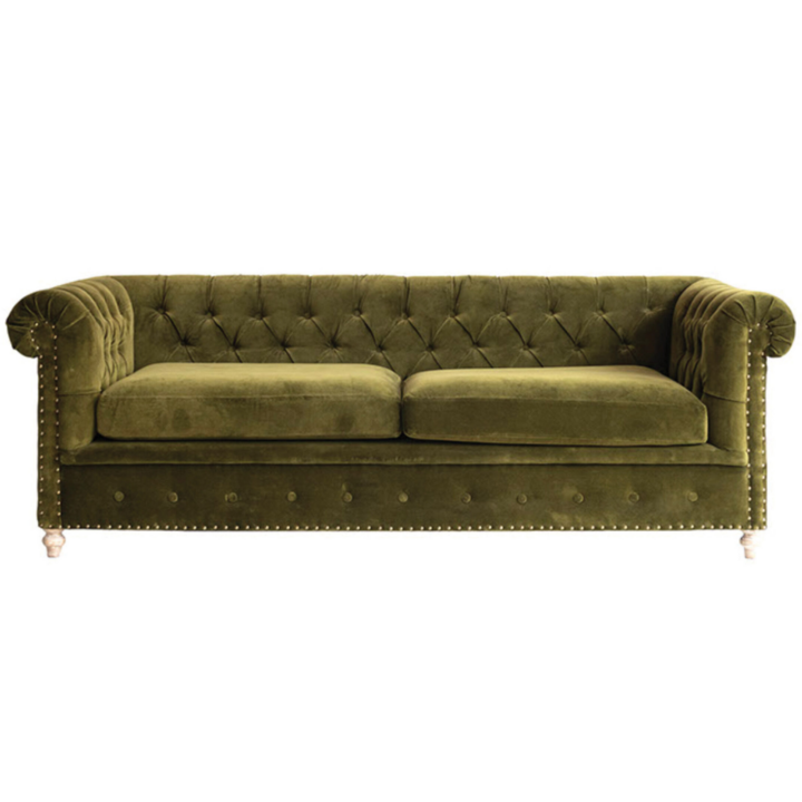 Green velvet Chesterfield sofa with deep button tufting, rolled arms, and nailhead trim.