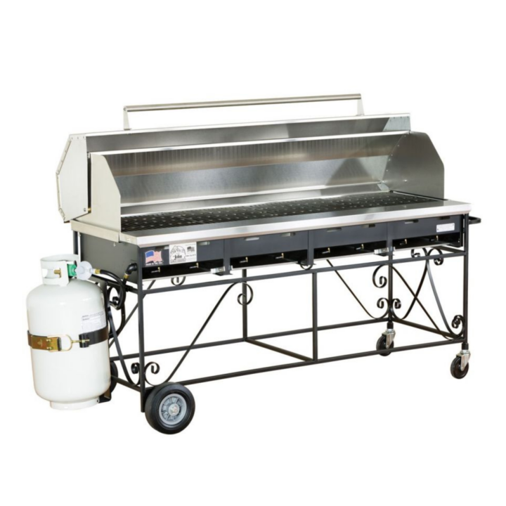 Large propane grill on a rolling metal cart with stainless steel cooking surface, side splash guards, and attached propane tank; ideal for outdoor catering and event cooking.