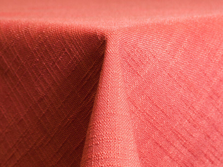 Coral Panama linen round tablecloth featuring a soft woven texture for weddings and events.