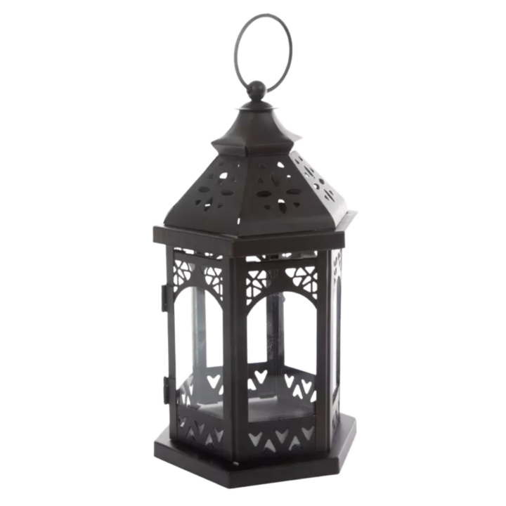 Black hexagonal metal lantern with glass panels and decorative cutout detailing, 5.5 inches wide by 11.5 inches high, ideal for candles and event table décor