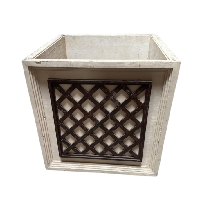 2-foot square treillage planter featuring a distressed white wood frame with decorative dark lattice panel detailing on each side.
